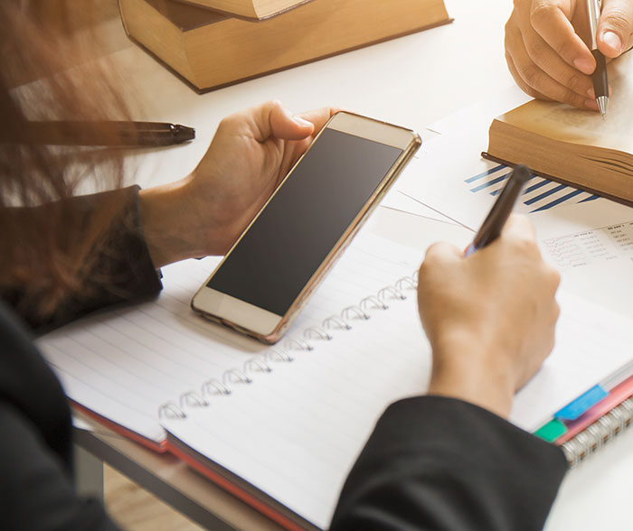 Lawyer researching with smartphone.